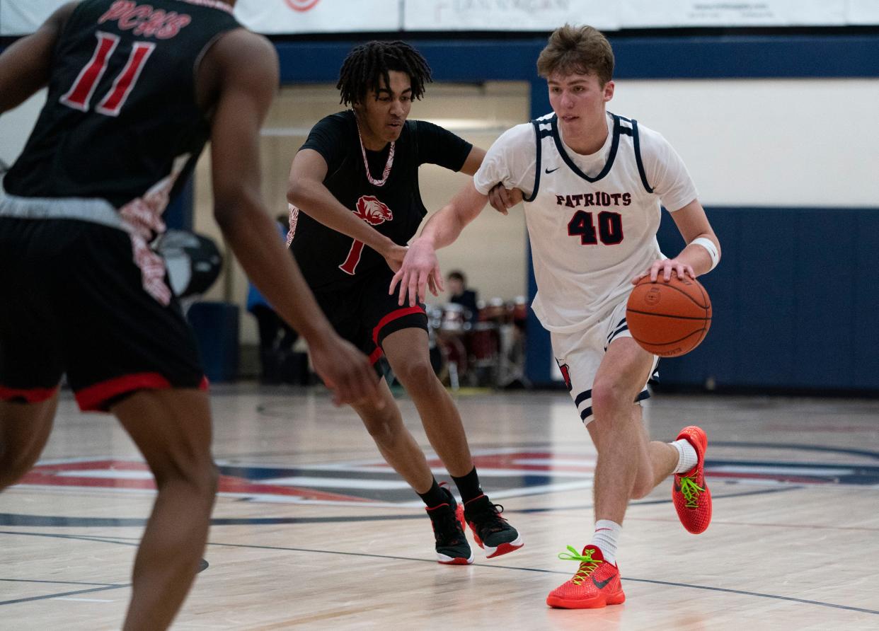 Heritage Hills’ Trent Sisley (40) drives as the Heritage Hills Patriots play the Princeton Tigers at Heritage Hills High School In Lincoln City, Ind., Tuesday, Feb. 20, 2024.