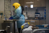 A nurse assists a COVID-19 patient at El Centro Regional Medical Center in El Centro, Calif., Tuesday, July 21, 2020. (AP Photo/Jae C. Hong)