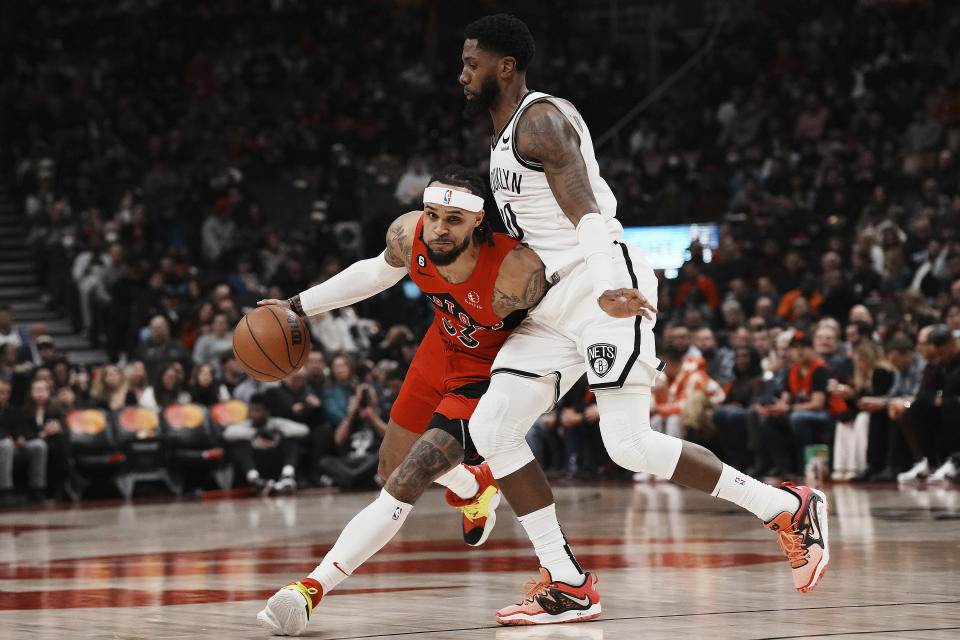 Toronto Raptors' Gary Trent Jr., left, drives past Brooklyn Nets' Royce O'Neale during the first half of an NBA basketball game Wednesday, Nov. 23, 2022, in Toronto. (Chris Young/The Canadian Press via AP)