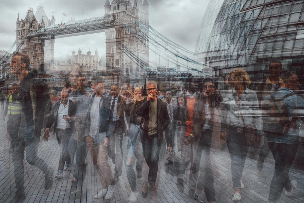 A man stares unflinchingly at the camera amid the buzz of London life and the backdrop of the iconic Tower Bridge: Burnham Arlidge