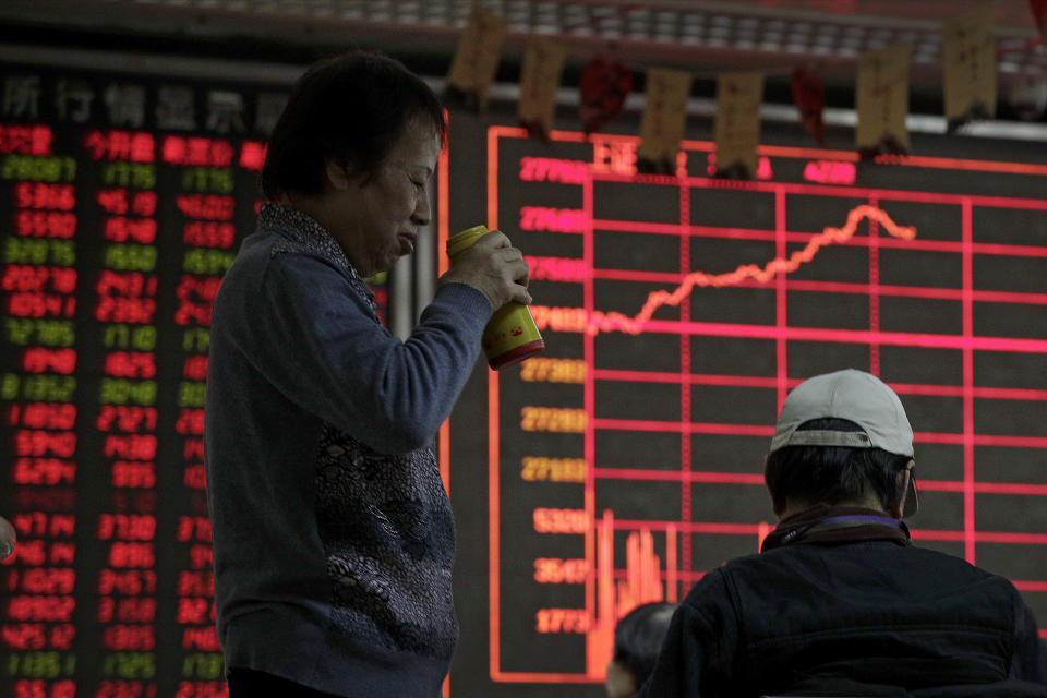 Investors chat as they monitor stock prices at a brokerage house in Beijing, Wednesday, Jan. 9, 2019. Shares extended gains in Asia on hopes for progress in resolving the tariffs battle between the U.S. and China as talks appeared to have been extended in Beijing. (AP Photo/Andy Wong)