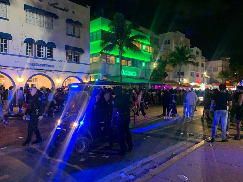 Miami Beach police struggled to clear people off Ocean Drive to allow cars to pass through on Thursday night.