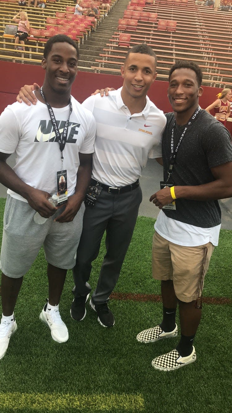 Iowa State recruits Breece Hall (left) and Jirehl Brock (right) pose for a photo with Cyclones running backs coach Nate Scheelhaase.