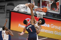 Cleveland Cavaliers center Jarrett Allen, back, blocks a shot by Washington Wizards forward Chandler Hutchison (1) during the second half of an NBA basketball game Friday, May 14, 2021, in Washington. Cavaliers guard Jeremiah Martin is at left. (AP Photo/Nick Wass)