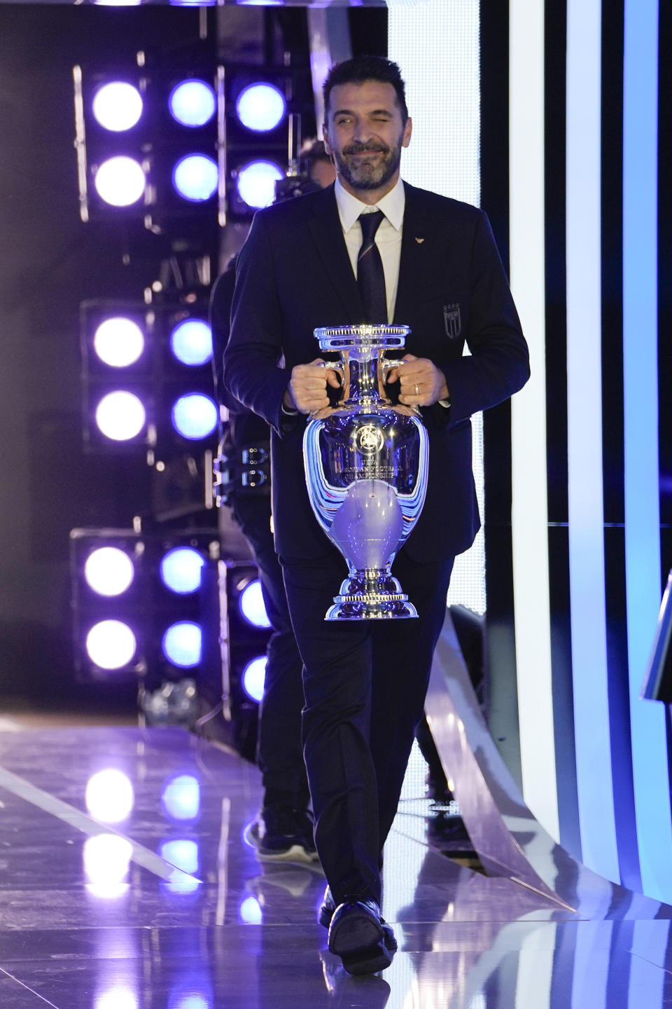 Former soccer Gianluigi Buffon arrives with the Euro 2024 trophy during the draw for the UEFA Euro 2024 soccer tournament finals in Hamburg, Germany, Saturday, Dec. 2, 2023. (AP Photo/Martin Meissner)