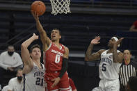 Wisconsin's D'Mitrik Trice (0) drives to the basket between Penn State's John Harrar (21) and Jamari Wheeler (5) during the second half of an NCAA college basketball game, Saturday, Jan. 30, 2021, in State College, Pa. (AP Photo/Gary M. Baranec)