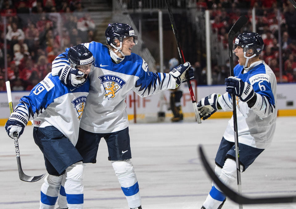 Finland's Elliot Desnoyers (19), Aleksi Heimosalmi (21) and Eemil Viro (6) celebrate a goal against Canada during the third period of the world junior hockey championship gold medal game in Edmonton, Alberta, Saturday Aug. 20, 2022. (Jason Franson/The Canadian Press via AP)