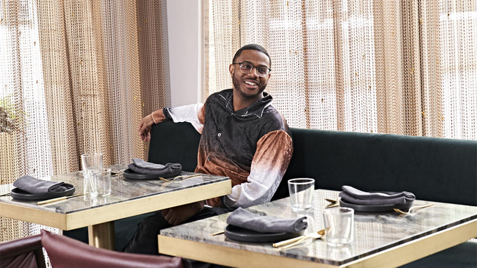 Chef Kwame Onwuachi seated at Tatiana