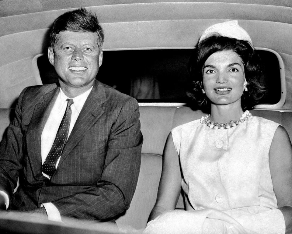 The Kennedys sit in a car at Idlewild Airport.