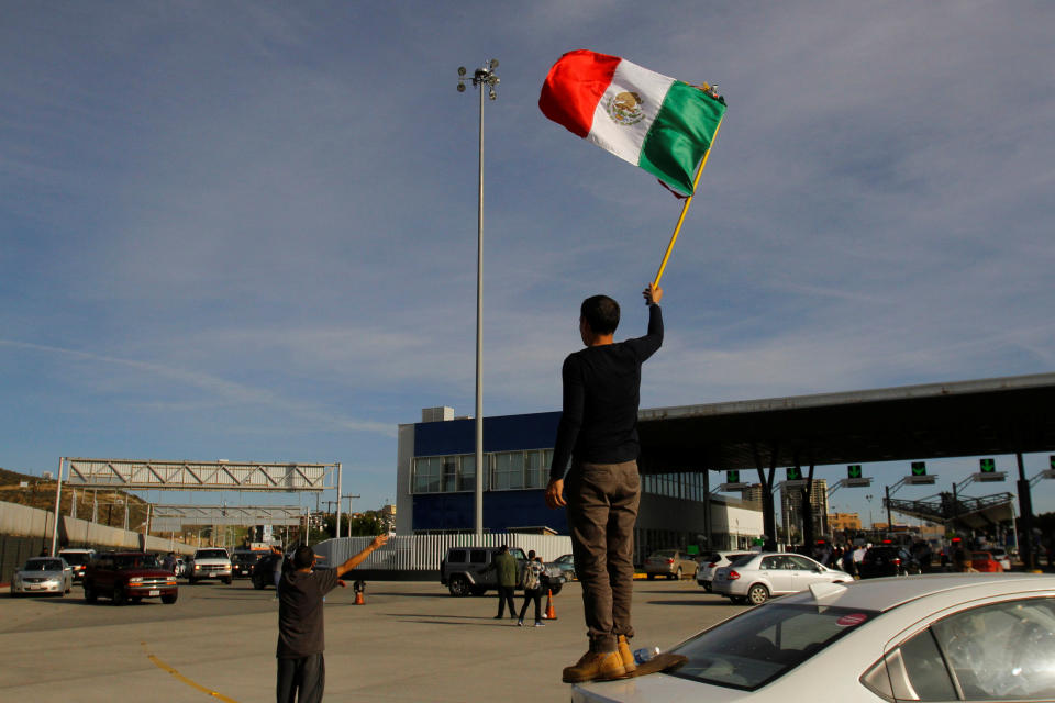 Mexico flag Tijuana border crossing checkpoint protest