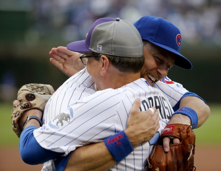 Chicago Cubs' Ben Zobrist, right, hugs his father Tom before his father threw out a ceremonial first pitch to him before a baseball game between the Cubs and the Colorado Rockies Thursday, June 8, 2017, in Chicago. (AP Photo/Charles Rex Arbogast)