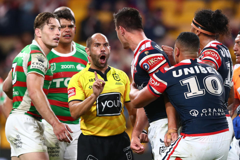 Referee Ashley Klein (pictured middle) speaks with Joseph Manu during a match.