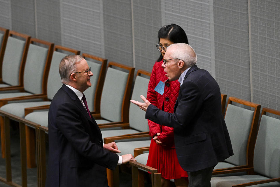 Professor Sean Turnell and his wife Dr. Ha Vu talk with Australian Prime Minister Anthony Albanese, left, during Question Time in the House of Representatives at Parliament House in Canberra, Australia, Thursday, Dec. 1, 2022. Turnell, an Australian economist who spent almost two years imprisoned in Myanmar, received a hero’s welcome Thursday at Australia’s Parliament House where lawmakers rose in a standing ovation and the prime minister praised his courage, optimism and resilience. (Lukas Coch/AAP Image via AP)