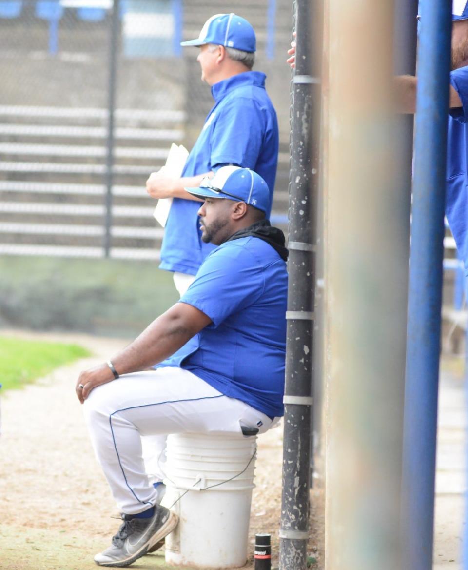 Cambridge head coach Jamaal Lowery has a front row seat beside assistant coach John Valentine during Tuesday's Division II sectional championship game at Don Coss Stadium.