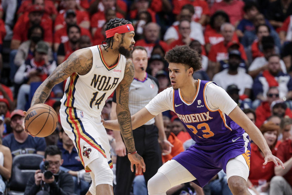 Brandon Ingram (14) dribbles against Phoenix Suns forward Cameron Johnson (23) during the first half of game four of the first round of the 2022 NBA playoffs at Smoothie King Center. Mandatory Credit: Stephen Lew-USA TODAY Sports