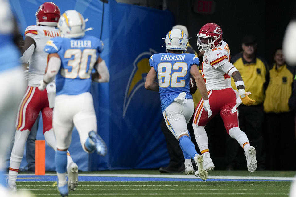 Kansas City Chiefs safety Mike Edwards, right, looks back as he runs back a fumble recovery for a touchdown during the first half of an NFL football game against the Los Angeles Chargers, Sunday, Jan. 7, 2024, in Inglewood, Calif. (AP Photo/Mark J. Terrill)