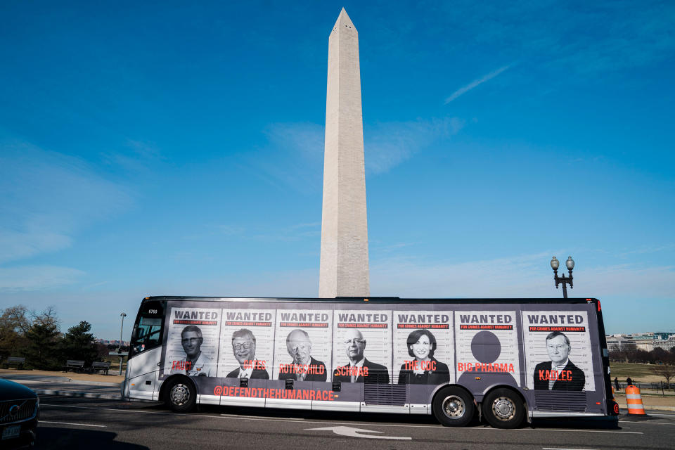 A bus with photos of prominent scientific and tech community members is seen ahead of a Defeat the Mandates march in Washington.<span class="copyright">Kent Nishimura—Los Angeles Times/Getty Images</span>