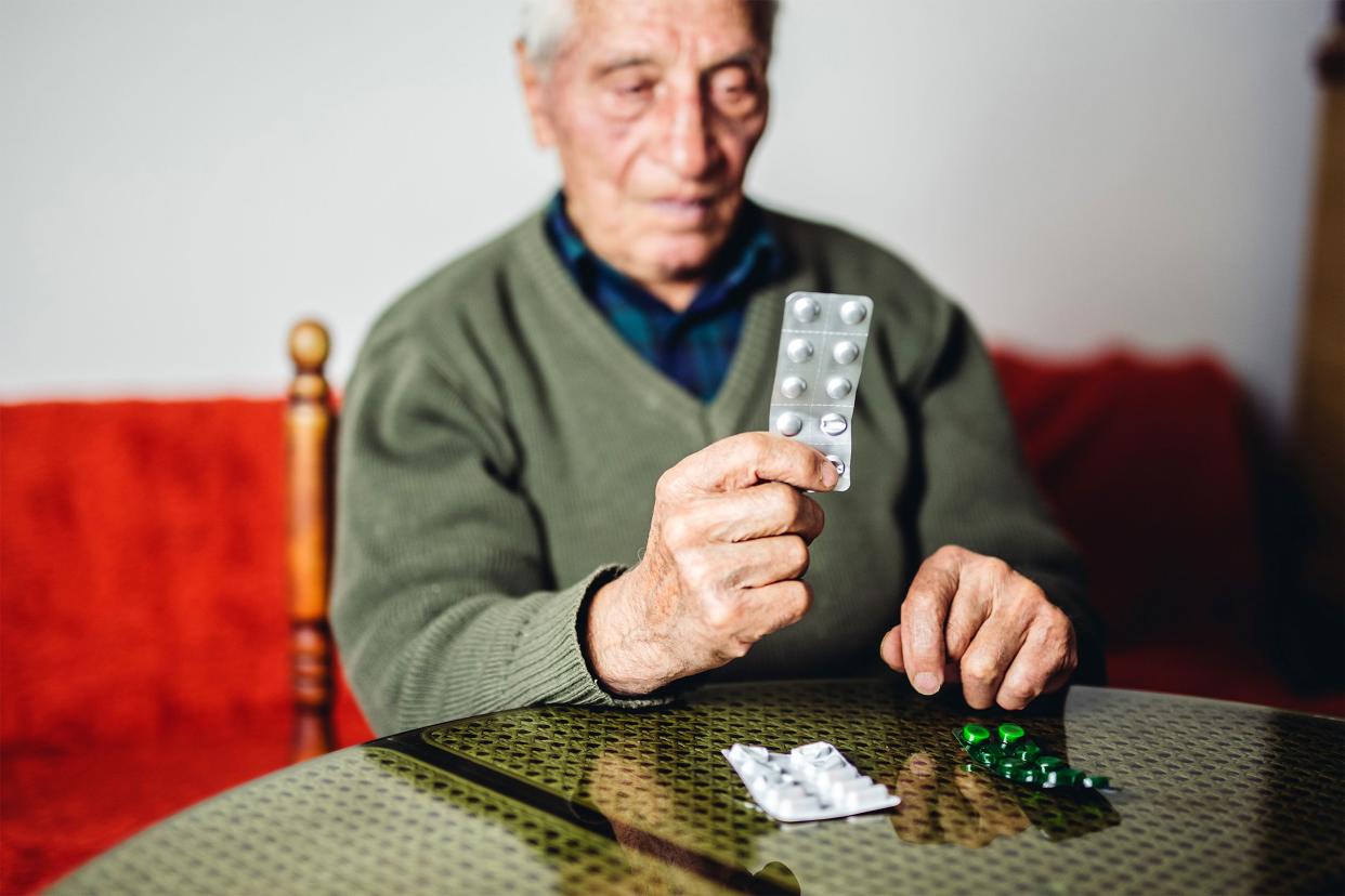 Senior man taking his medication