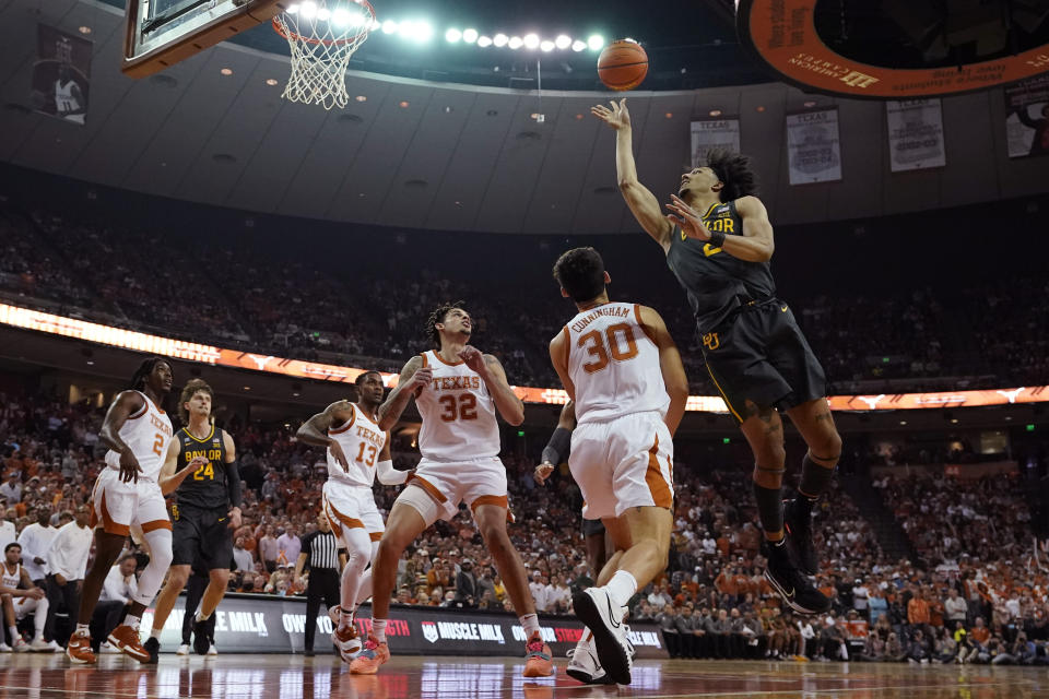 Baylor guard Kendall Brown, right, shoots over Texas forward Brock Cunningham (30) during the first half of an NCAA college basketball game Monday, Feb. 28, 2022, in Austin, Texas. (AP Photo/Eric Gay)