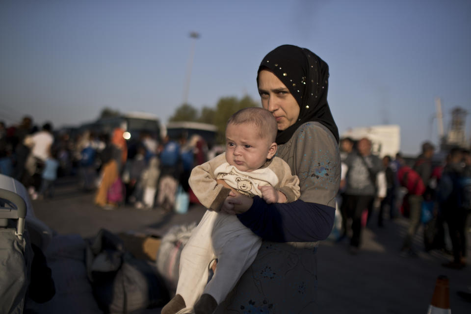 19 year old Nermi Zeitoun from Idlib , Syria, holds her three month old baby Mohhamed Lousman after they disembark from a ferry, at the port of Piraeus, near Athens, Tuesday, Sept. 25, 2018. About 400 migrants and refugees arrived at the port from the island of Lesbos as authorities have been moving hundreds of migrants deemed to be vulnerable from the overcrowded Moria camp to camps on the mainland.(AP Photo/Petros Giannakouris)