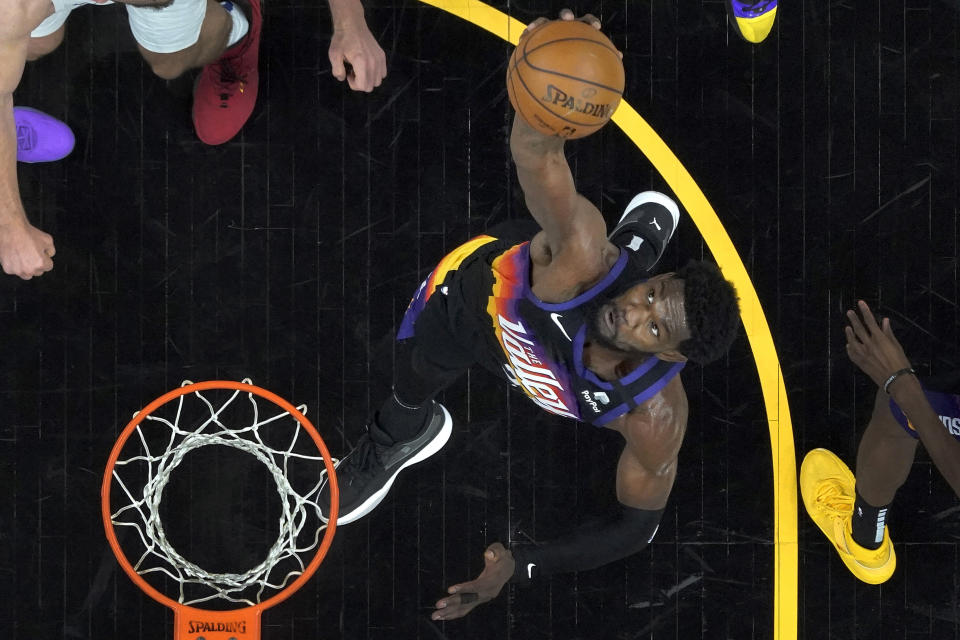 Phoenix Suns center Deandre Ayton rebounds during the first half of game 2 of the NBA basketball Western Conference Finals against the Los Angeles Clippers, Tuesday, June 22, 2021, in Phoenix. (AP Photo/Matt York)