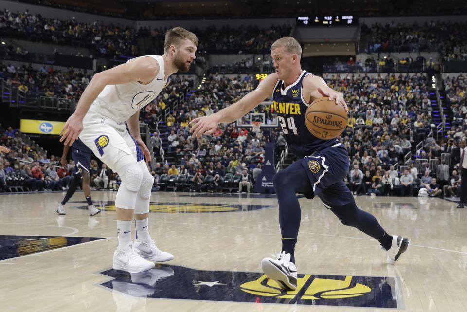 Denver Nuggets' Mason Plumlee (24) goes to the basket against Indiana Pacers' Domantas Sabonis (11) during the first half of an NBA basketball game Thursday, Jan. 2, 2020, in Indianapolis. (AP Photo/Darron Cummings)