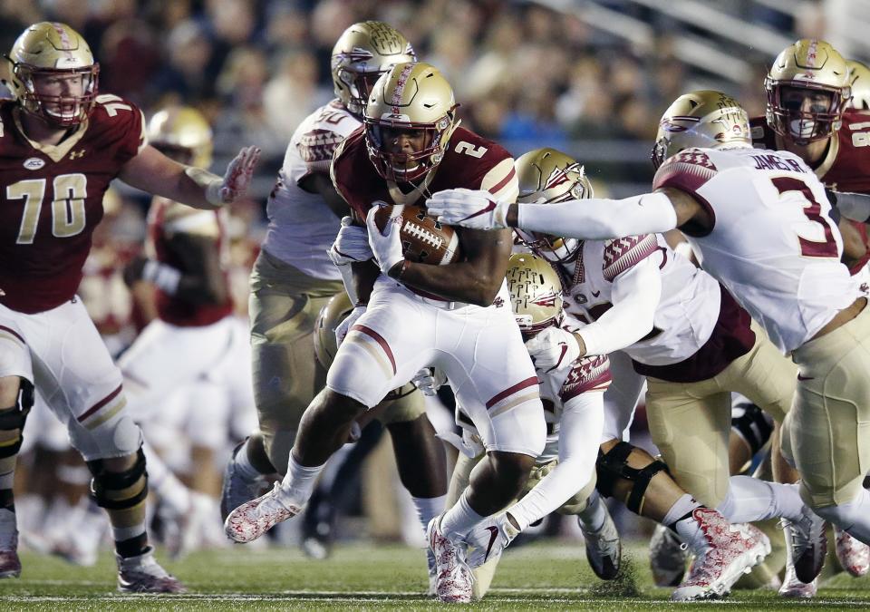 Boston College running back AJ Dillon (2) carries the ball against Florida State defensive back Derwin James (3) during the first half on an NCAA college football game in Boston, Friday, Oct. 27, 2017. (AP Photo/Michael Dwyer)