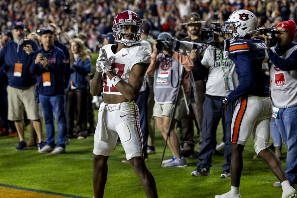 Alabama wide receiver Isaiah Bond (17) reacts after catching a touchdown pass in the final minute on a fourth-and-long play to secure a win over Auburn during the second half of an NCAA college football game, Saturday, Nov. 25, 2023, in Auburn, Ala. (AP Photo/Vasha Hunt)