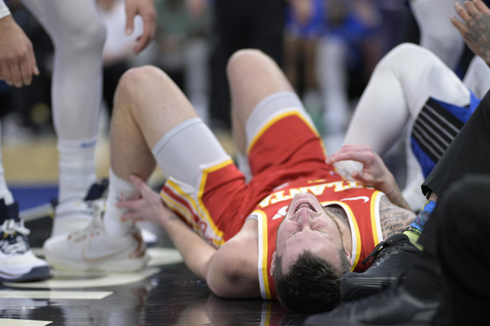 Atlanta Hawks guard Garrison Mathews reacts on the floor after getting injured during the first half of an NBA basketball game against the Orlando Magic, Sunday, Jan. 7, 2024, in Orlando, Fla. (AP Photo/Phelan M. Ebenhack)