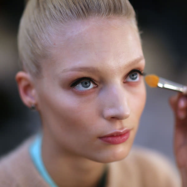 A model has her make-up applied backstage at the Temperley show © Getty