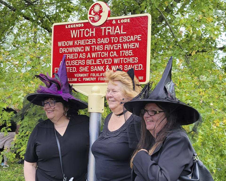 In this Sept. 16, 2023 photo, provided by Alexina Jones, people dressed as witches gather near a newly installed marker, in Pownal, Vt., that recognizes the survivor of Vermont's only recorded witch trial. Widow Krieger was said to have escaped drowning in the Hoosic River when tried as a witch in 1785, according to the Legends and Lore marker. (Alexina Jones via AP)