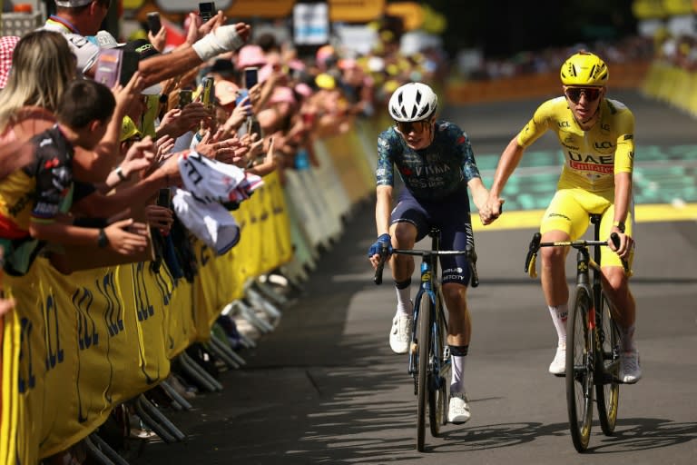 Tadej Pogacar in yellow takes the day's winner Jonas Vingegaard's hand (Anne-Christine POUJOULAT)