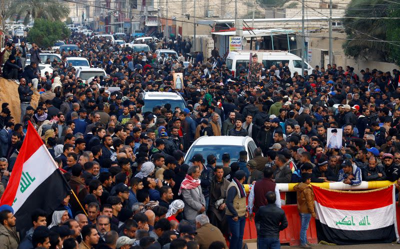 Supporters of Iraqi Shi'ite cleric Moqtada al-Sadr gather near his home, after it was attacked, in the holy city of Najaf