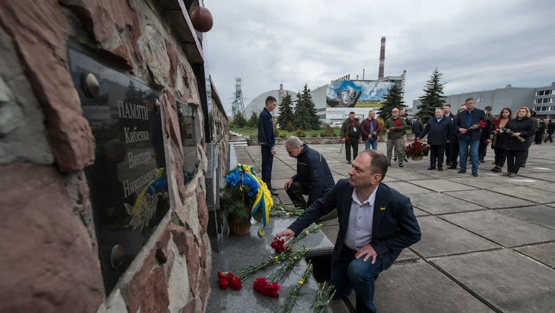 Chernobyl's nuclear power plant workers lay flowers at a monument to the victims of the Chernobyl tragedy during a memorial ceremony in Chernobyl, Ukraine, Wednesday, April 26, 2023. Ukrainian President Volodymyr Zelenskyy on Wednesday used the 37th anniversary of the world’s worst nuclear disaster to repeat his warnings about the potential threat of a new atomic catastrophe in Ukraine amid his country's war with Russia.