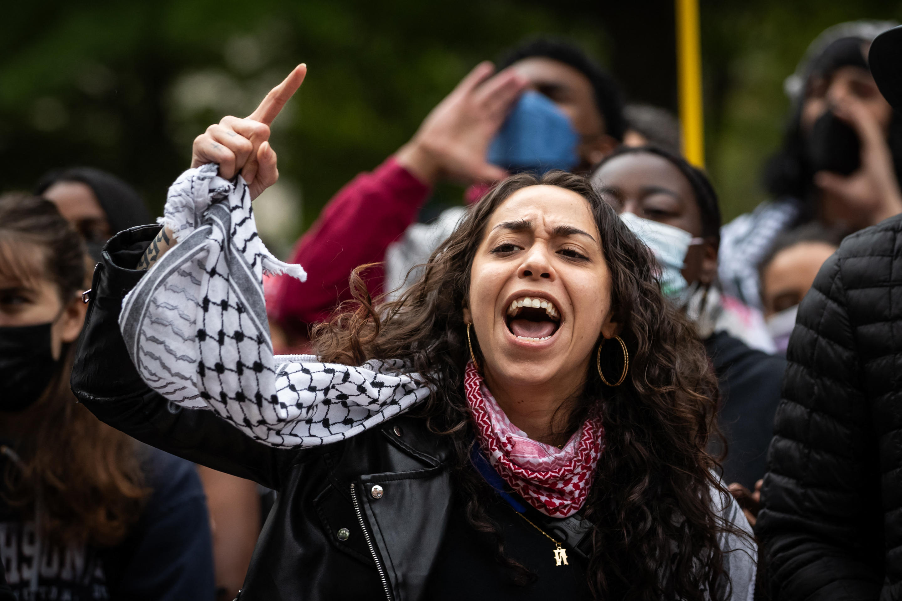 A demonstrator chants during a rally at an encampment at George Washington University.