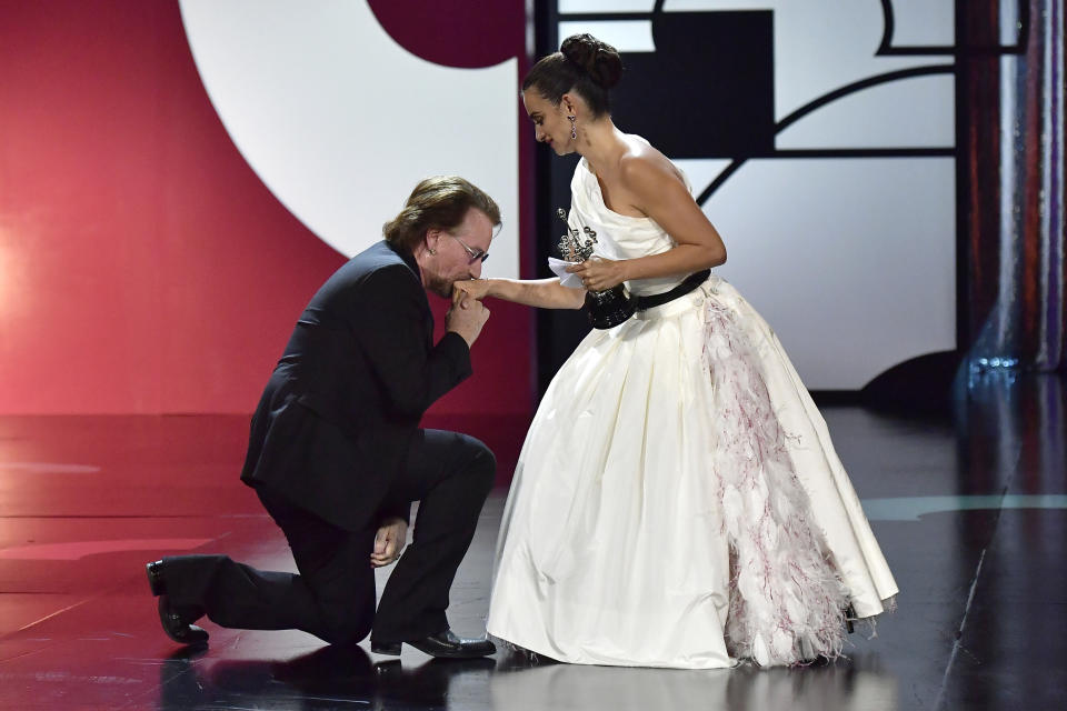 El cantante Bono, izquierda, besa la mano de la actriz española Penélope Cruz, quien acaba de recibir el Premio Donostia en la 67ma edición del Festival de Cine de San Sebastián en San Sebastián, España, 27 de septiembre de 2019. (AP Foto/Alvaro Barrientos)