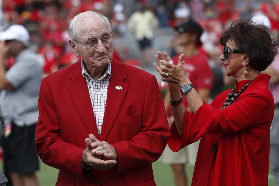 FILE -Former head Georgia football coach and athletic director Vince Dooley and his wife Barbara react during a ceremony to name the field at Sanford Stadium in his honor before an NCAA college football game against the Murray State Saturday, Sept. 7, 2019, in Athens, Ga. Vince Dooley, the football coach who carried himself like a professor and guided Georgia for a quarter-century of success that included the 1980 national championship, died Friday, Oct. 28, 2022. He was 90. (AP Photo/John Bazemore, File)