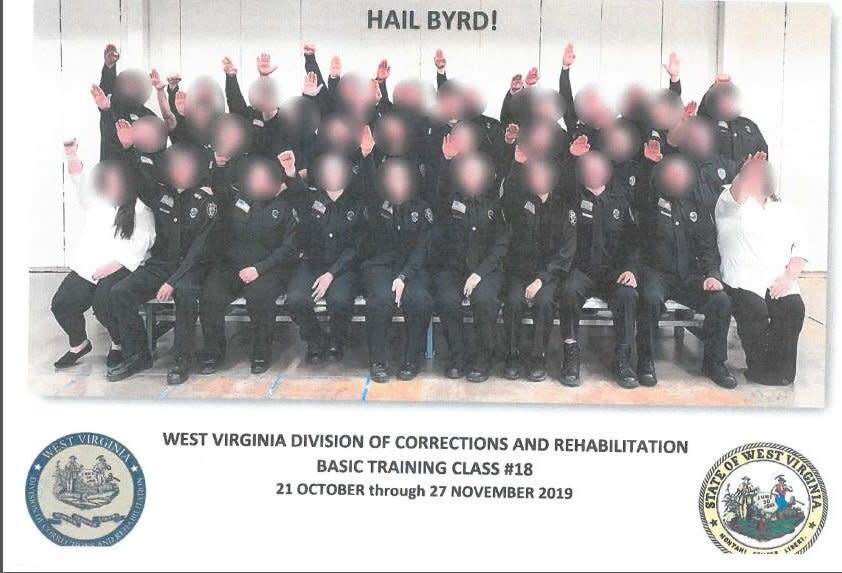 Government employees working for West Virginia's Division of Corrections and Rehabilitation make a Nazi salute in a class photo that surfaced in December.