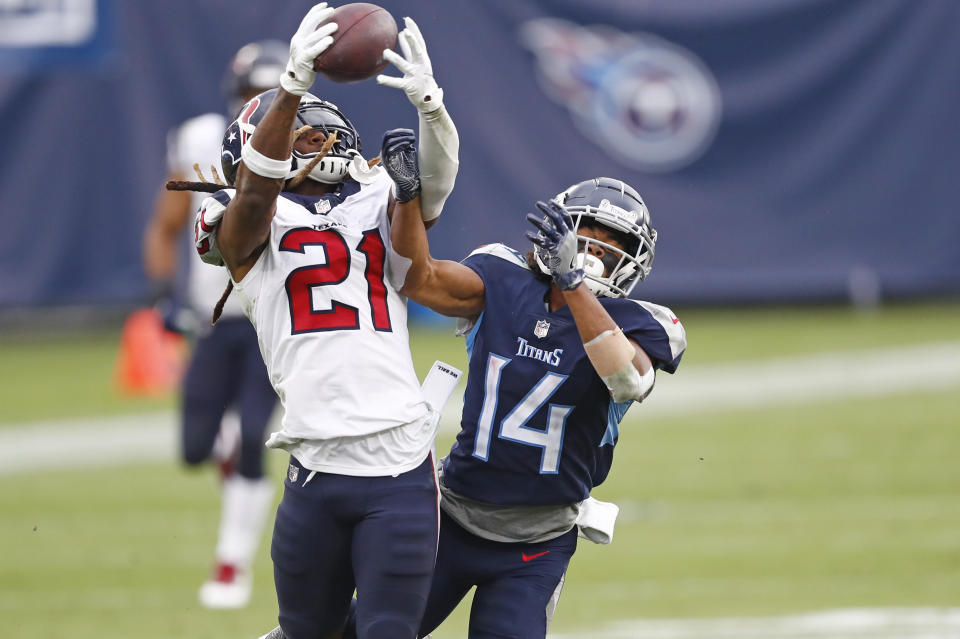 Houston Texans cornerback Bradley Roby (21) intercepts a pass intended for Tennessee Titans wide receiver Kalif Raymond (14) in the second half of an NFL football game Sunday, Oct. 18, 2020, in Nashville, Tenn. (AP Photo/Wade Payne)