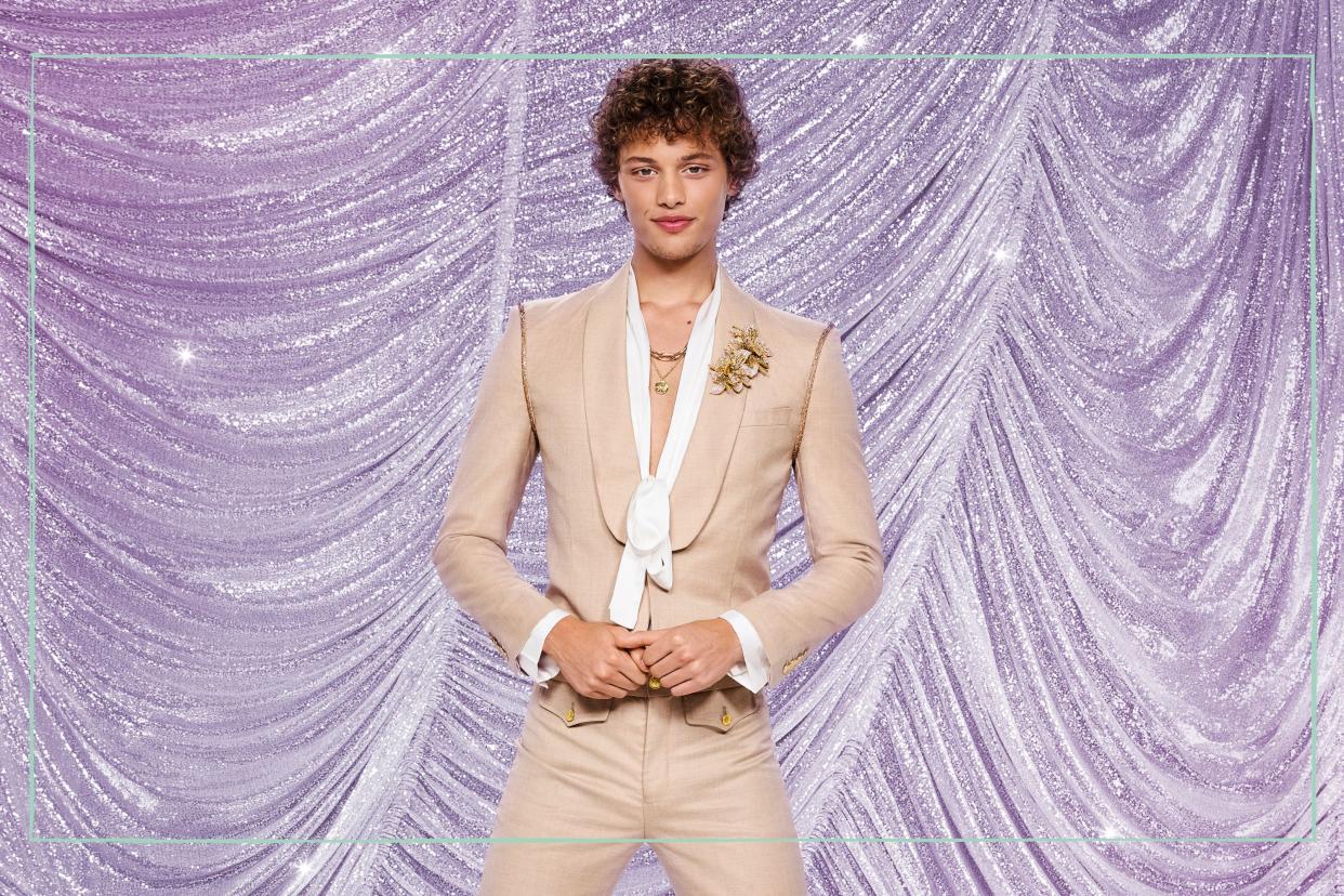  Bobby Brazier posing in front of a glittery purple background. 