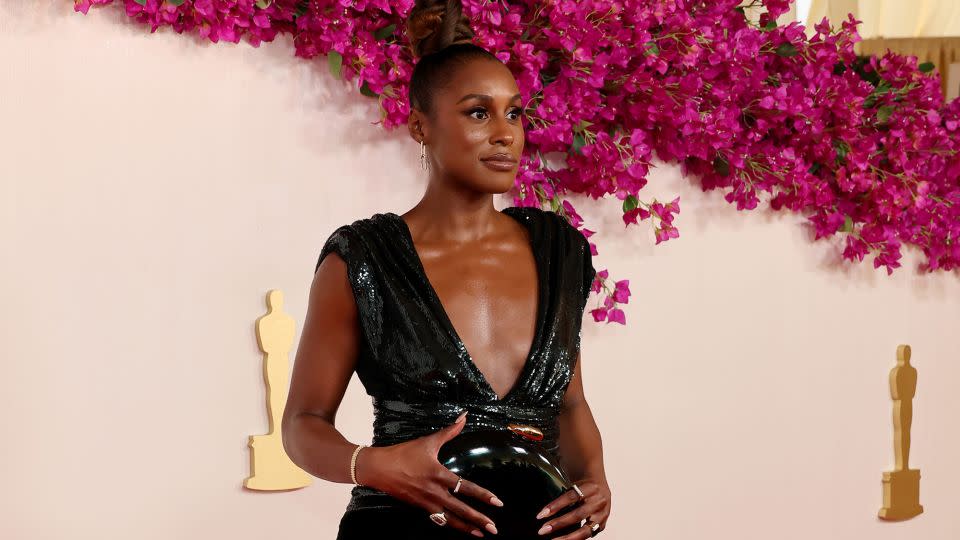 Issa Rae, who featured in two nominated movies ("Barbie" and "American Fiction"), stunned in a plunging AMI Paris dress paired with Gianvito Rossi shoes. - Mike Coppola/Getty Images