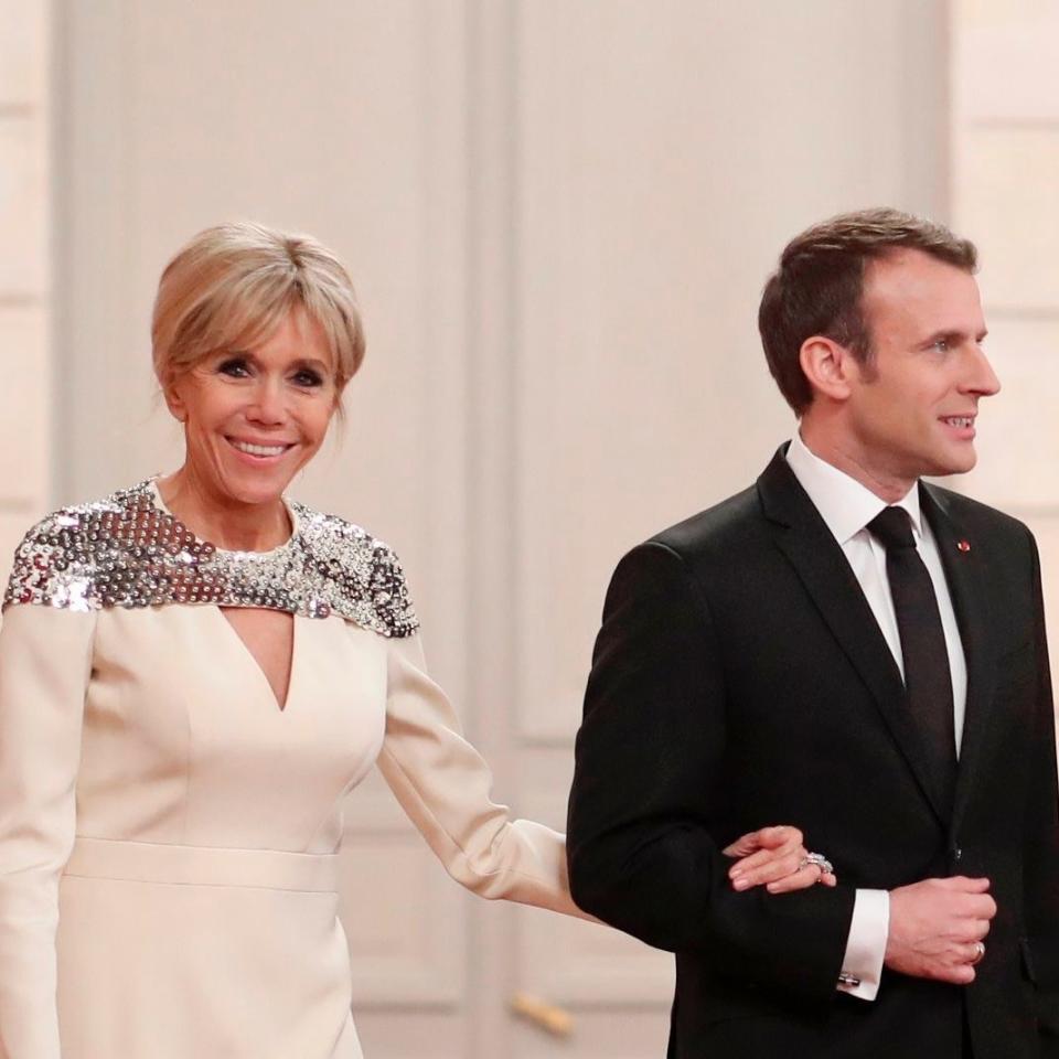 The French First Lady Brigitte Macron opted for a floor-skimming dress with a shimmering silver finish.