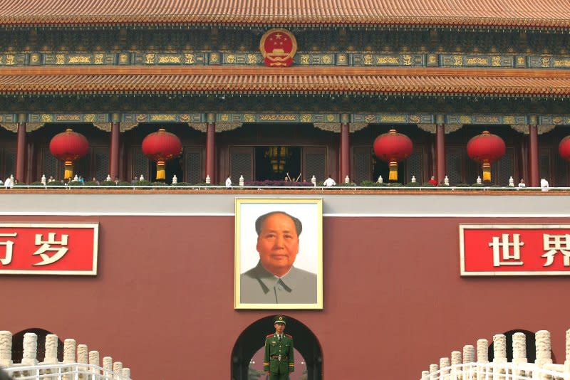 A Chinese soldier stands guard in front of a giant portrait of China's former helmsan Mao Zedong hanging in Tiananmen Square's north gate in Beijing on China's National Day, October 1, 2006. Mao's funeral was held in the square on September 18, 1976. File Photo by Stephen Shaver/UPI