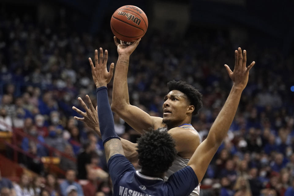Kansas' David McCormack shoots over Nevada's Warren Washington during the first half of an NCAA college basketball game Wednesday, Dec. 29, 2021, in Lawrence, Kan. (AP Photo/Charlie Riedel)