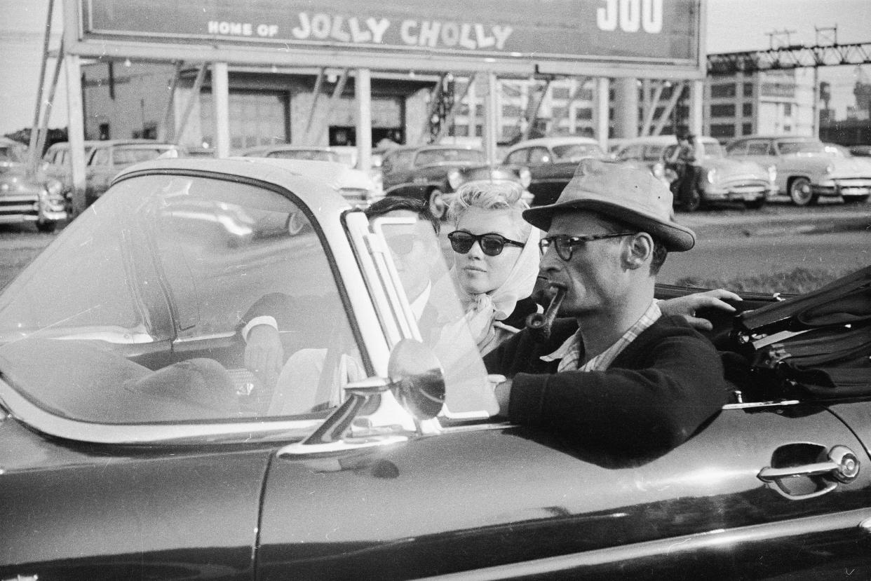 Marilyn Monroe rides in a car with her friend, photographer Milton Greene, and her husband, Arthur Miller, right, in 1956 in New York City. (Photo: Paul Schutzer/The Life Images Collection/Getty Images)