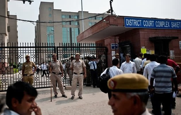 Police stand guard outside the Saket Court Complex in New Delhi on September 13, 2013. A judge has sentenced four men to death for the fatal gang rape of an Indian student on a bus last December, triggering applause inside the packed courtroom