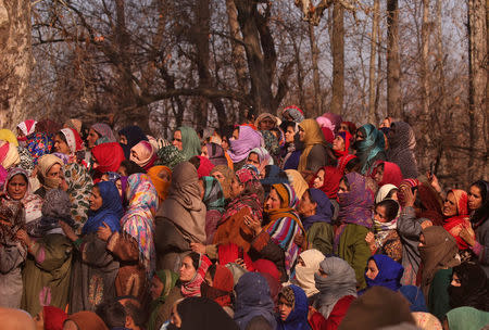 Women gather to watch the body of Zahoor Ahmad, a suspected militant, who according to local media reports was killed during a gun battle with Indian soldiers, during his funeral in Sirnoo village in south Kashmir's Pulwama district December 15, 2018. REUTERS/Danish Ismail