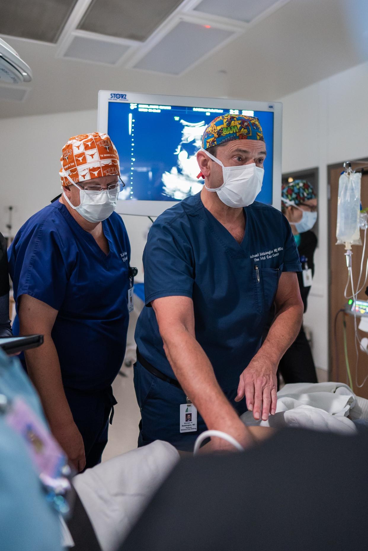 At Dell Children's, Dr. Kenneth Moise Jr., left, and Dr. Michael Bebbington watch screens to see how Jeannette Becerra's babies are positioned while they insert a tube, then a scope and then a laser into Becerra's abdomen to cauterize blood vessels that connect her twins.