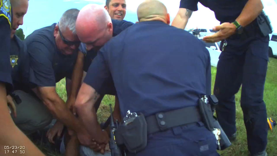 FILE - In this Saturday, May 23, 2020 image from Franklin Parish Sheriff's Office body camera video, law enforcement officers restrain Black motorist Antonio Harris, bottom center, on the side of a road after a high speed chase in Franklin Parish, La. In February 2024, Louisiana prosecutors have quietly dismissed charges against state police troopers who were recorded beating Harris and hoisting him to his feet by his hair braids before bragging in text messages that the “whoopin’” would give the man “nightmares for a long time.” (Aaron Touchet/Franklin Parish Sheriff's Office via AP, File)