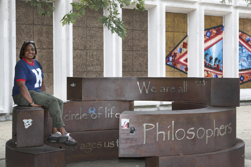 Karen Calloway, principal of Kenwood Academy in Chicago, poses Tuesday, July 28, 2020, for a portrait by the school's Inspirational Circle, designed by Kenwood students in 2003, in the Hyde Park neighborhood campus. School districts around the U.S. are working to remove police officers from campuses, but the school council for Kenwood Academy, a predominantly Black school near the University of Chicago, recently unanimously voted to keep its officer. (AP Photo/Charles Rex Arbogast)